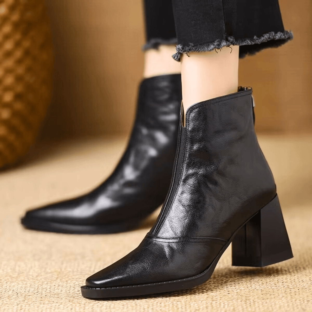 Black leather ankle boots with block heel, pointed toe and back zip, worn with cropped jeans - view 3