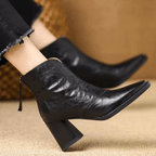 Black leather ankle boots with block heel, pointed toe and back zip, worn with cropped jeans - view 4