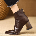 Black leather ankle boots with block heel, pointed toe and back zip, worn with cropped jeans - view 7