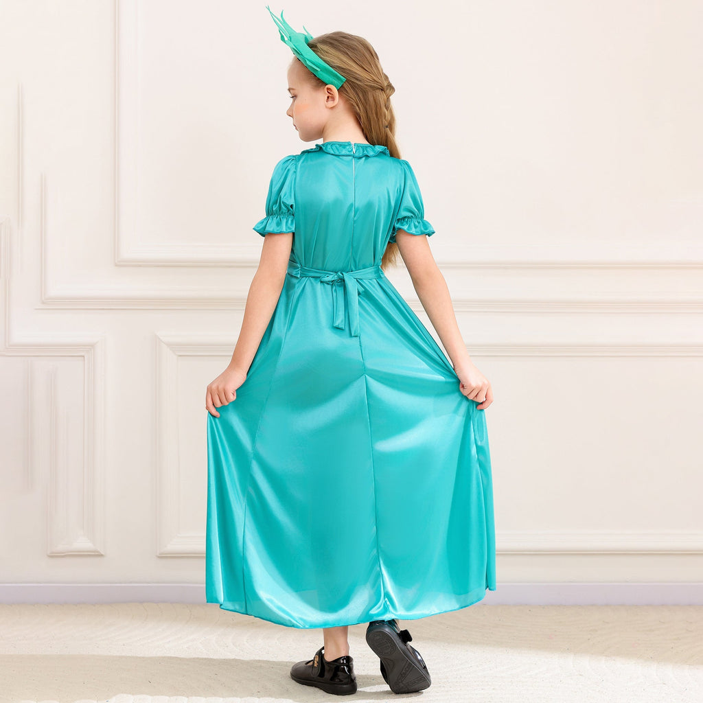 Girl wearing a teal satin-look Statue of Liberty costume dress with spiked crown headband and flame torch prop - view 2