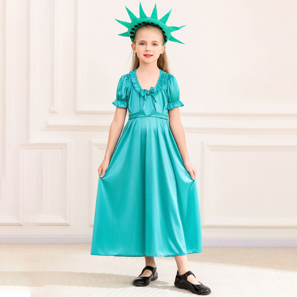 Girl wearing a teal satin-look Statue of Liberty costume dress with spiked crown headband and flame torch prop - view 4