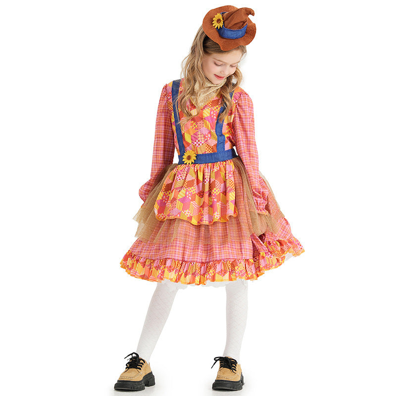 Girl wearing a pink plaid scarecrow Halloween costume dress with patchwork apron, sunflower and mini hat - view 3
