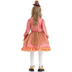 Girl wearing a pink plaid scarecrow Halloween costume dress with patchwork apron, sunflower and mini hat - view 4