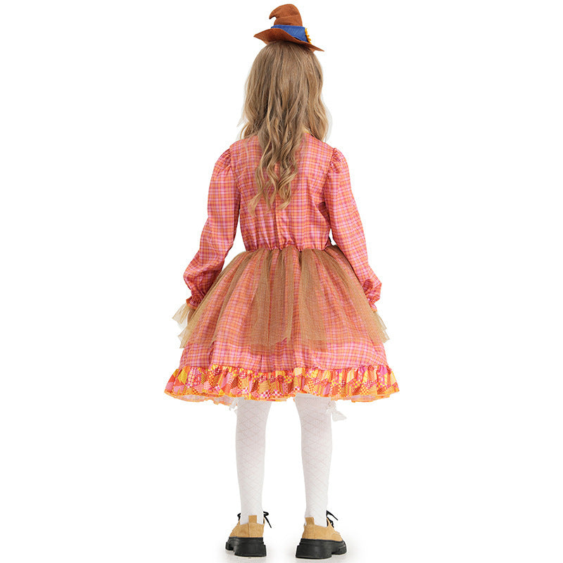 Girl wearing a pink plaid scarecrow Halloween costume dress with patchwork apron, sunflower and mini hat - view 4