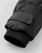 Women's black hooded puffer jacket with waist belt and cuff tabs - view 7