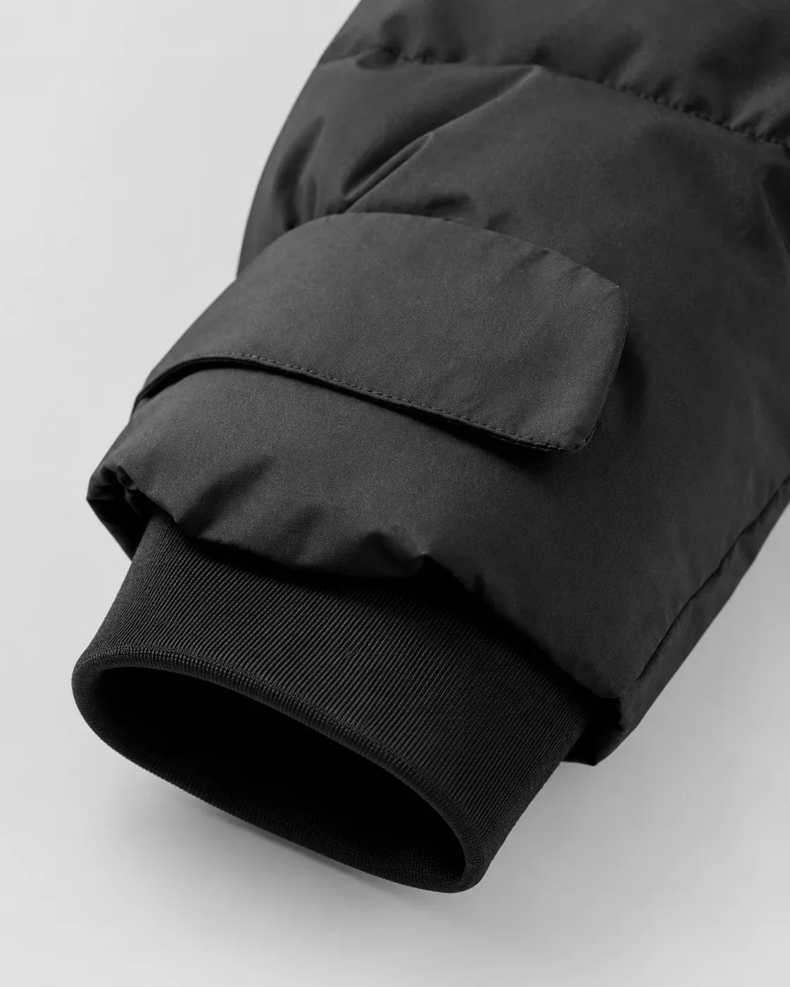 Women's black hooded puffer jacket with waist belt and cuff tabs - view 7
