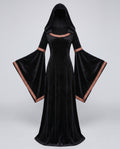 Woman wearing a black velvet hooded costume dress with bell sleeves and red and gold trim - view 5