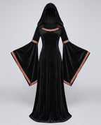 Woman wearing a black velvet hooded costume dress with bell sleeves and red and gold trim - view 5