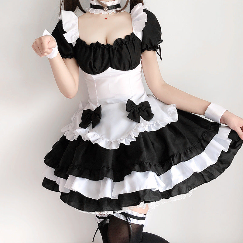 Black and white ruffled maid Halloween costume dress with puff sleeves, bow apron and tiered skirt
