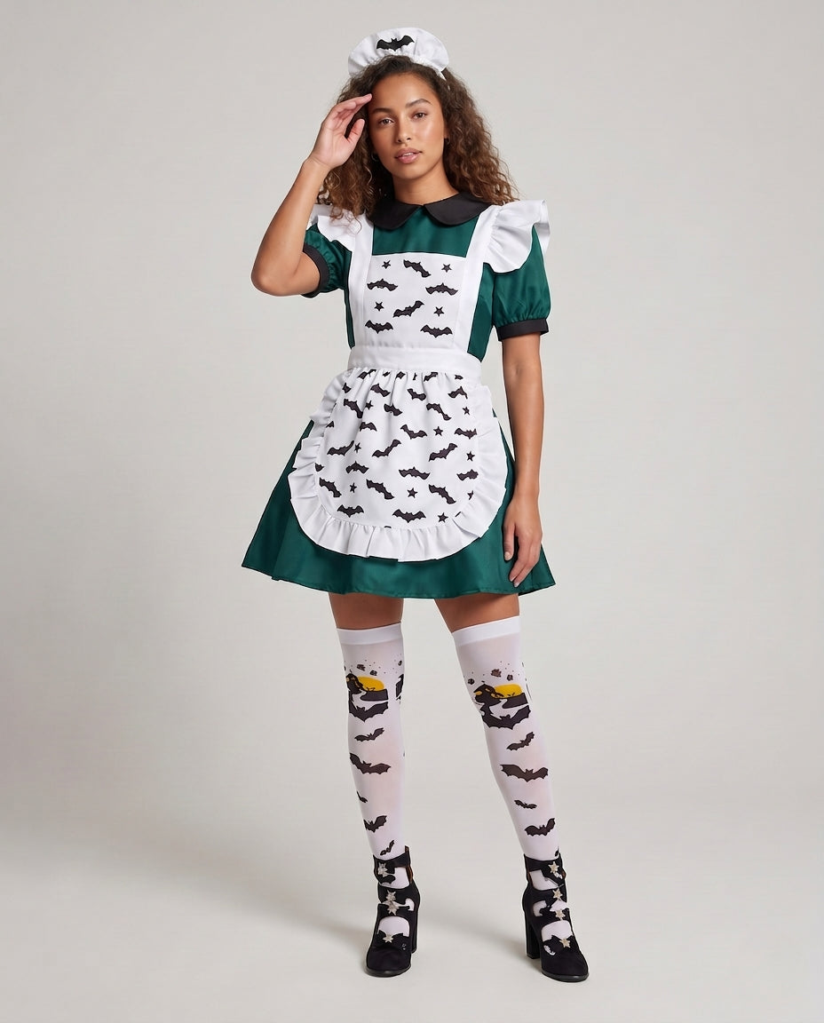 Woman wearing green Halloween costume dress with white bat-print ruffled apron