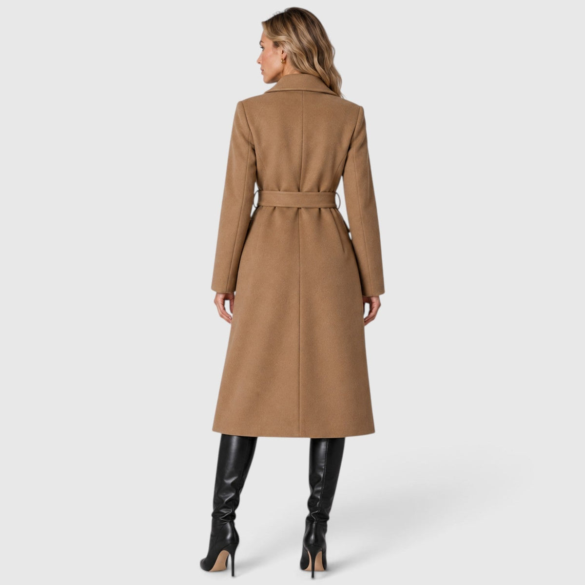 Woman wearing a long double breasted belted coat with wide lapels and knee-high boots - view 12
