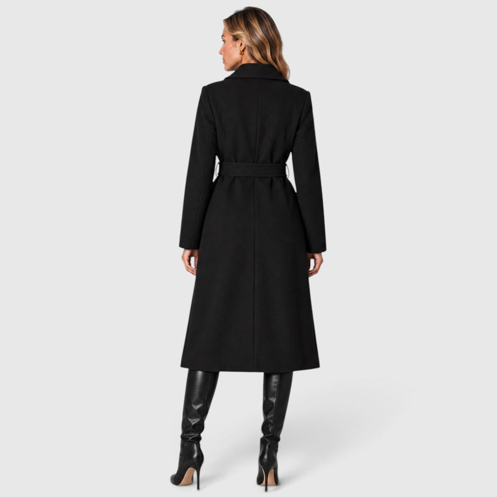 Woman wearing a long double breasted belted coat with wide lapels and knee-high boots - view 3