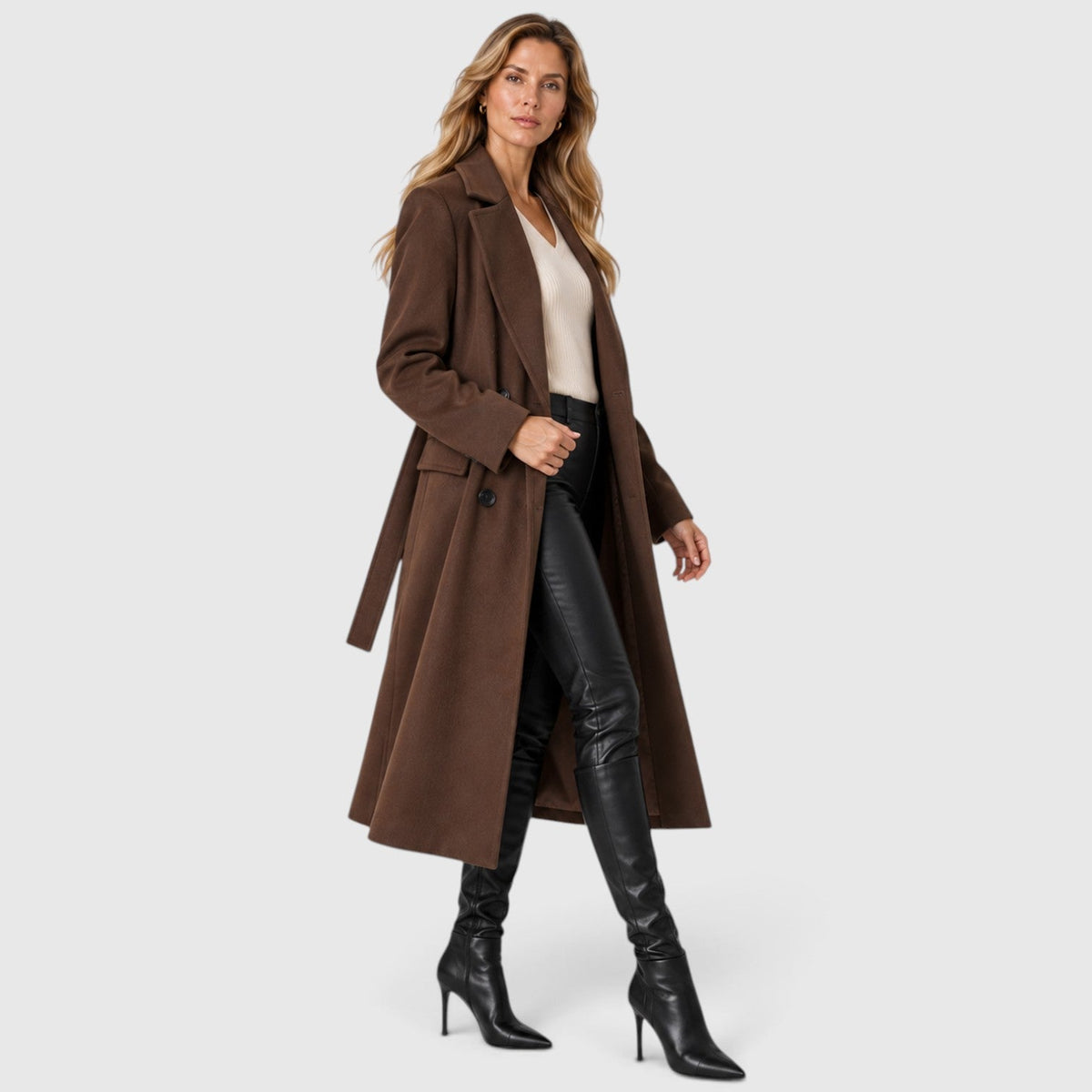 Woman wearing a long double breasted belted coat with wide lapels and knee-high boots - view 8