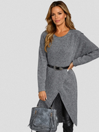 Woman wearing a gray ribbed wrap front long sleeve sweater dress with split high-low hem over black leggings - view 2