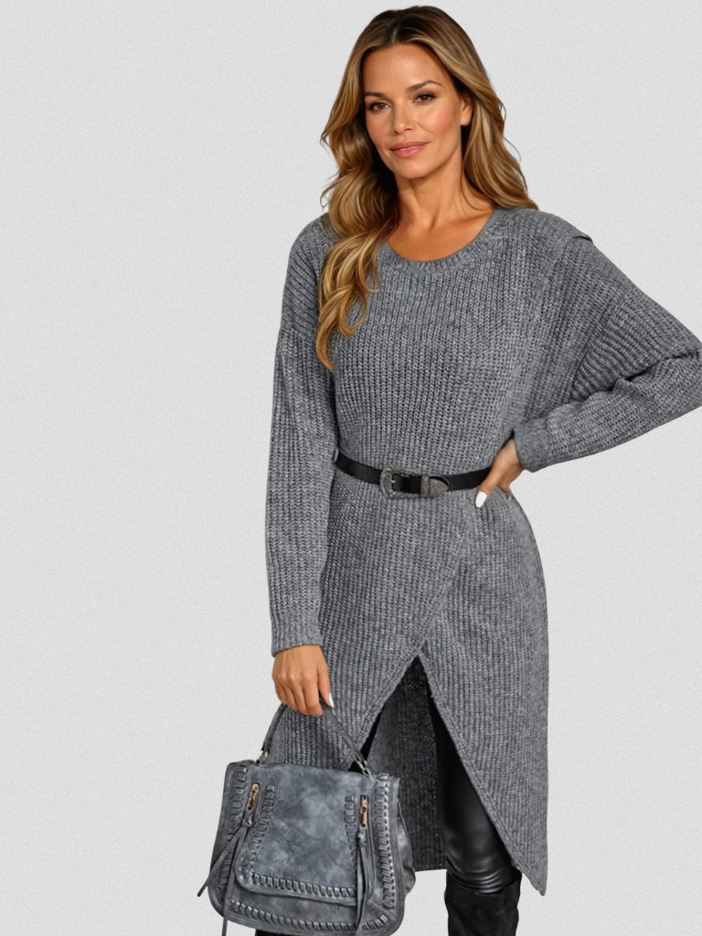 Woman wearing a gray ribbed wrap front long sleeve sweater dress with split high-low hem over black leggings - view 2