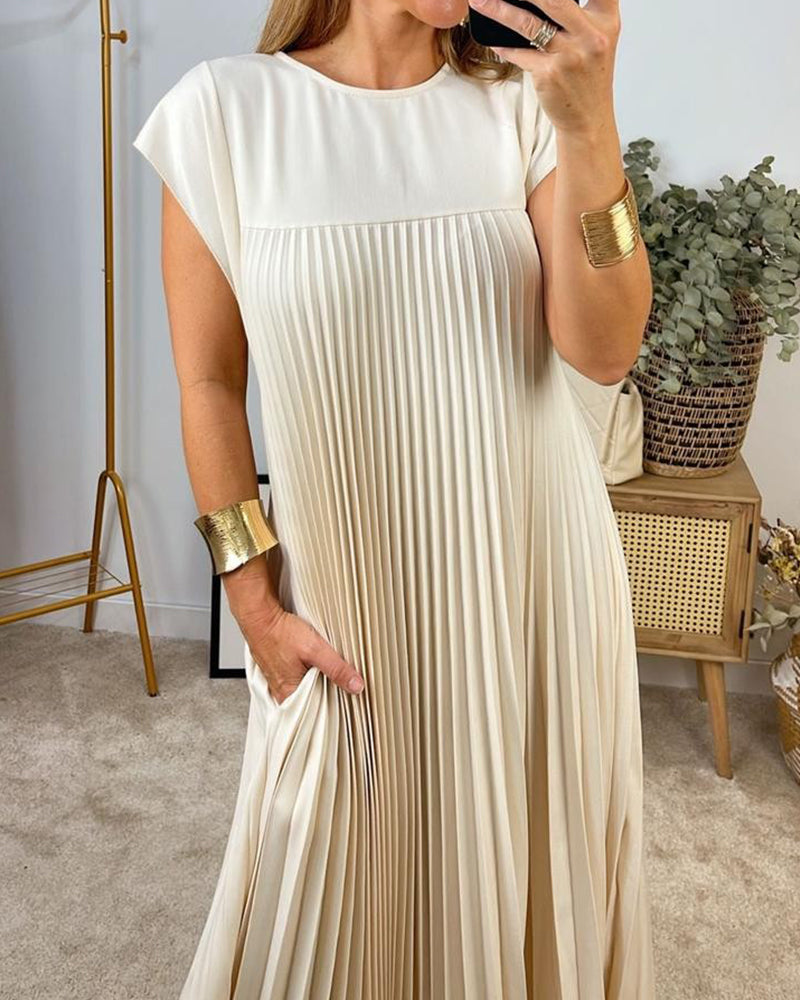 Woman wearing a pleated cap sleeve maxi dress with crew neck
