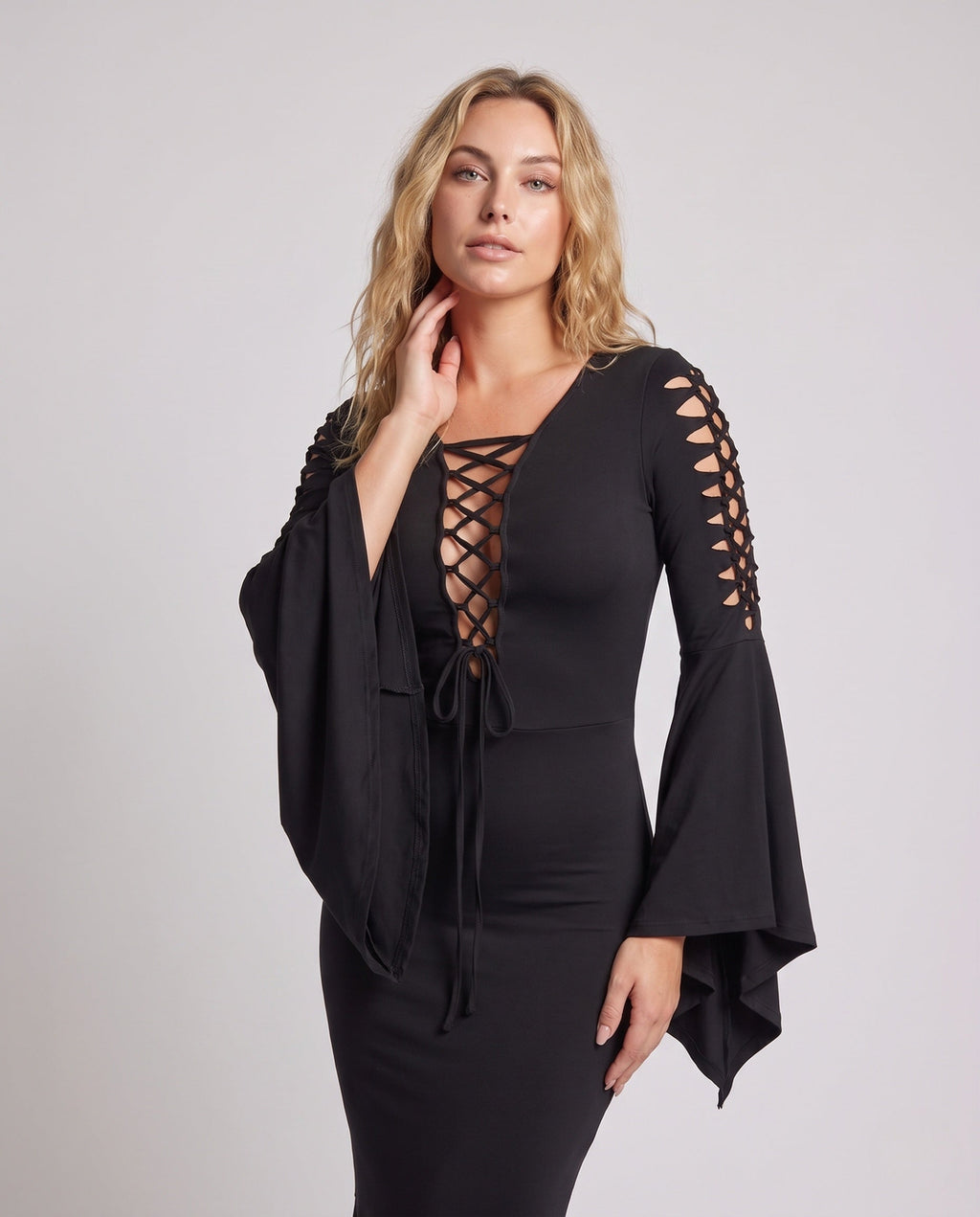 Woman wearing a black lace-up V-neck maxi dress with bell sleeves and mermaid handkerchief hem - view 2