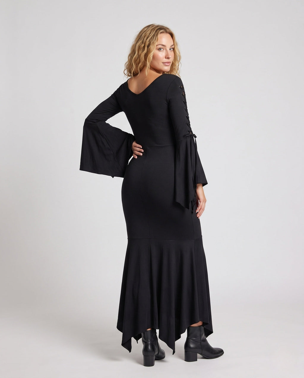 Woman wearing a black lace-up V-neck maxi dress with bell sleeves and mermaid handkerchief hem - view 4