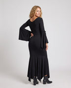 Woman wearing a black lace-up V-neck maxi dress with bell sleeves and mermaid handkerchief hem - view 4