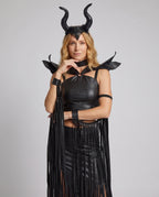 Woman in black leather-look horned Halloween costume with O-ring halter crop top and fringed slit skirt - view 2
