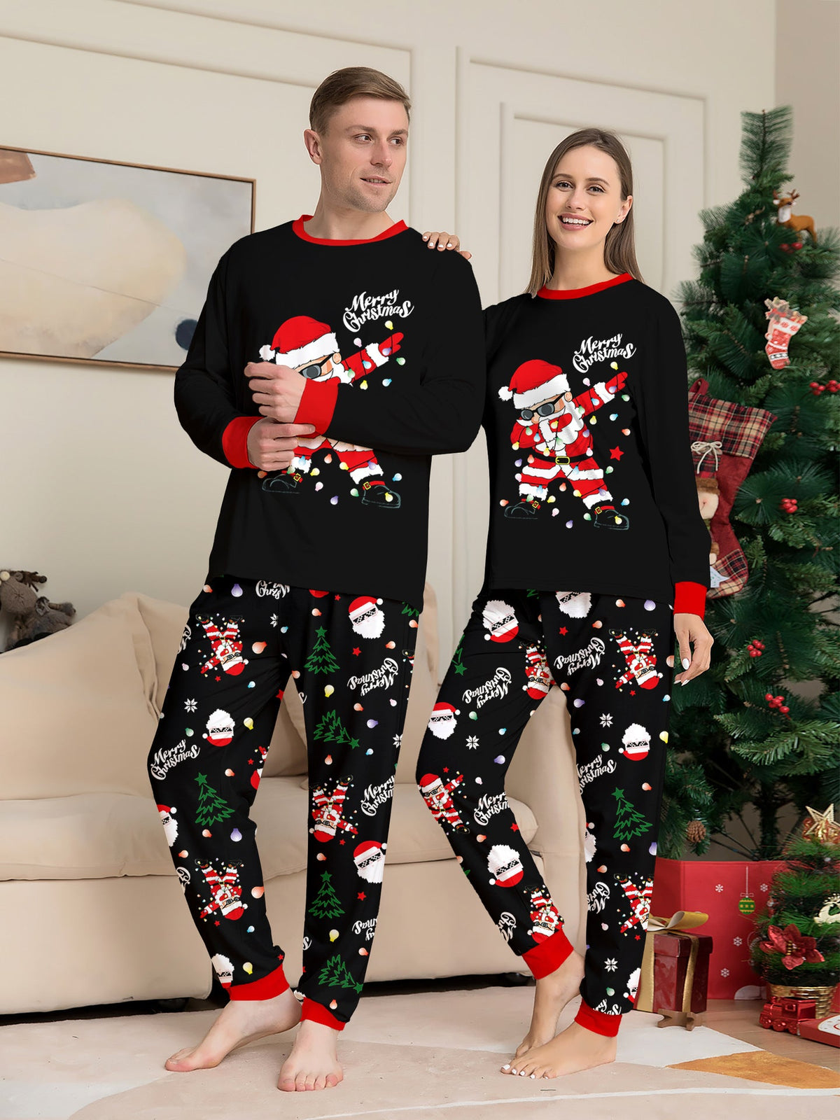 Matching family Christmas pajamas, black top with dabbing Santa graphic and Christmas print jogger pants with red cuffs - view 2