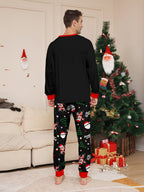 Matching family Christmas pajamas, black top with dabbing Santa graphic and Christmas print jogger pants with red cuffs - view 6