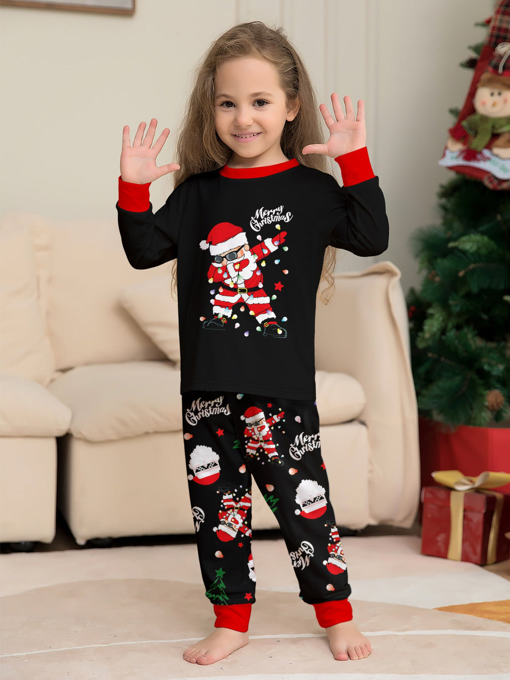 Matching family Christmas pajamas, black top with dabbing Santa graphic and Christmas print jogger pants with red cuffs - view 9