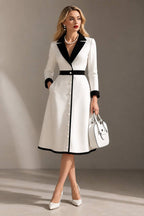 Formal white long sleeve coat dress with black lapels, cuffs and waistband