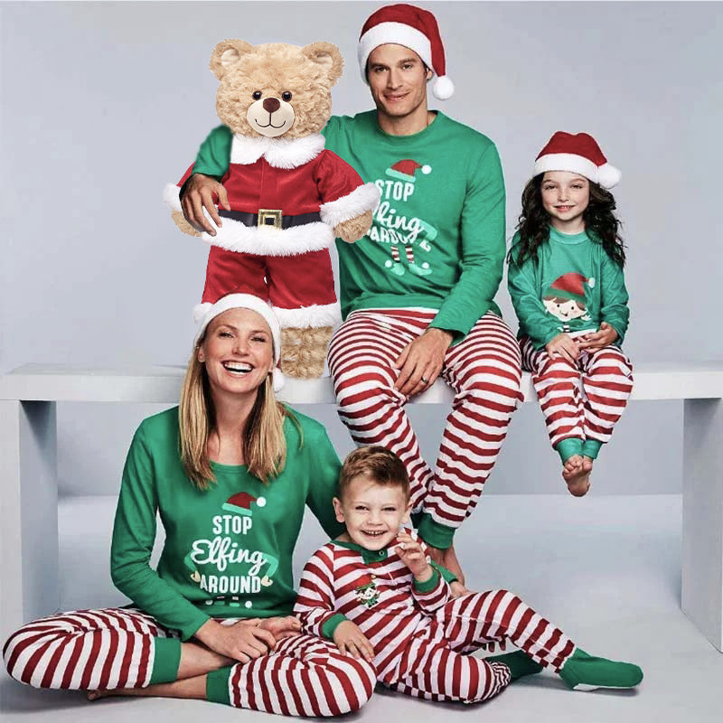 Matching family Christmas pajamas with green elf slogan tops and striped pants - view 2