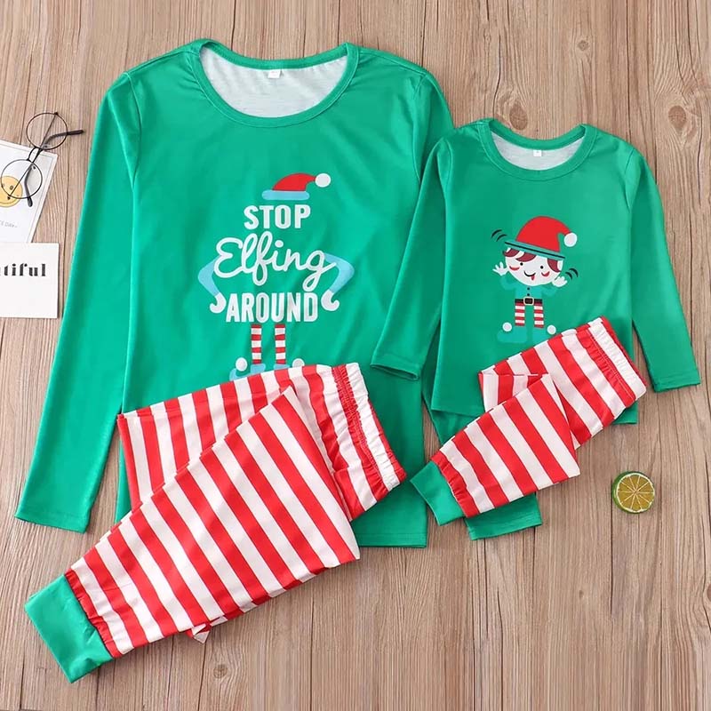 Matching family Christmas pajamas with green elf slogan tops and striped pants - view 7