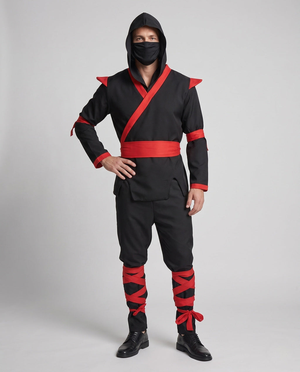 Men's black ninja Halloween costume with hood, red wrap trim, red sash and red leg wraps
