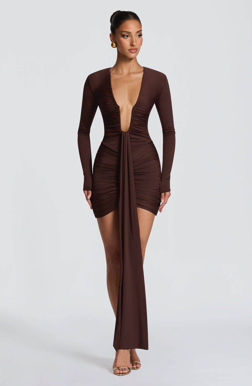 Brown long sleeve ruched bodycon mini dress with plunging neckline and long front drape