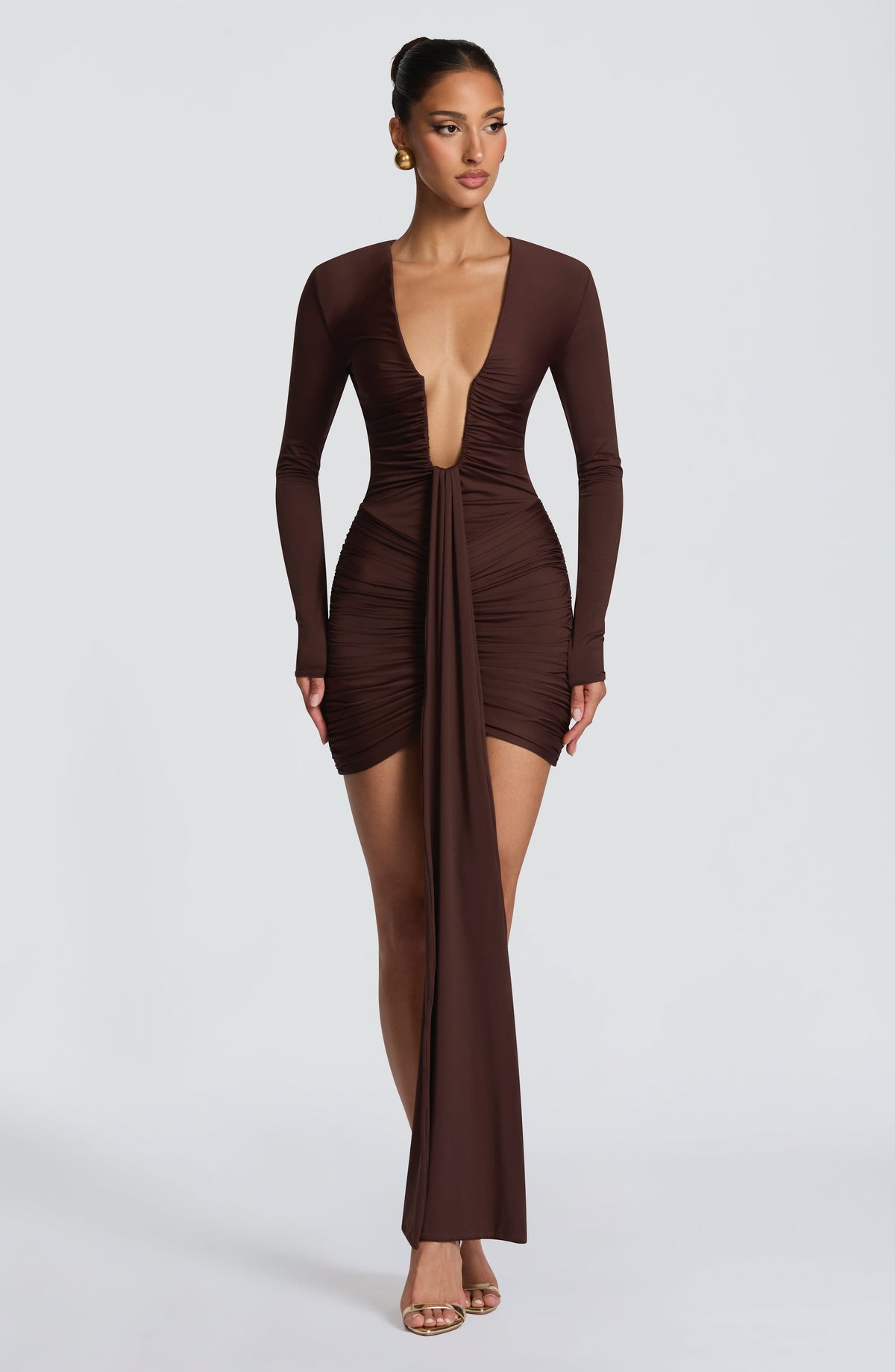 Brown long sleeve ruched bodycon mini dress with plunging neckline and long front drape