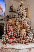 Matching red and white plaid family Christmas pajamas with red ribbed cuffs