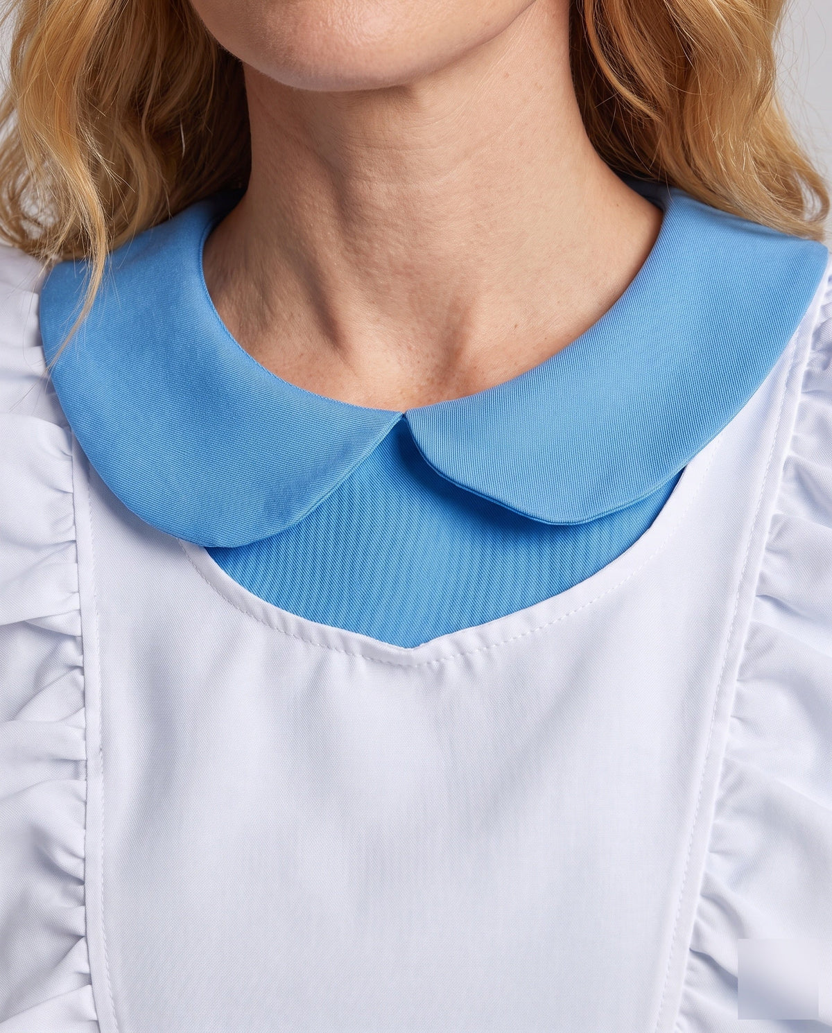 Woman wearing a blue fairytale costume dress with a white ruffled apron and Peter Pan collar - view 3