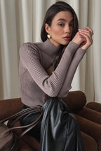 Woman wearing brown ribbed knit turtleneck sweater with keyhole cutout - view 2