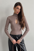 Woman wearing brown ribbed knit turtleneck sweater with keyhole cutout - view 3