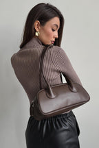 Woman wearing brown ribbed knit turtleneck sweater with keyhole cutout - view 6
