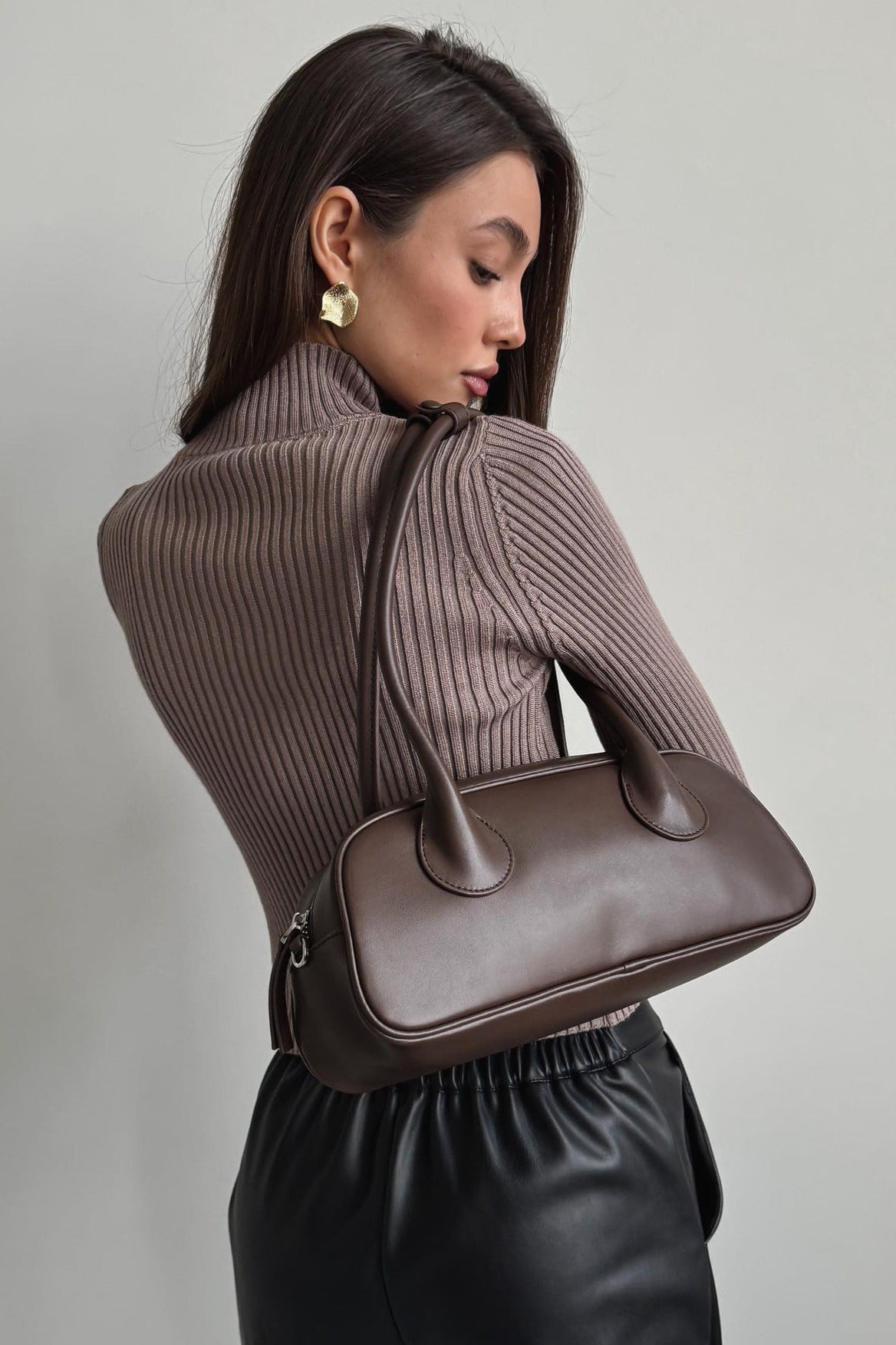 Woman wearing brown ribbed knit turtleneck sweater with keyhole cutout - view 6