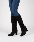 Black block heel knee high boots in faux suede worn with skinny jeans