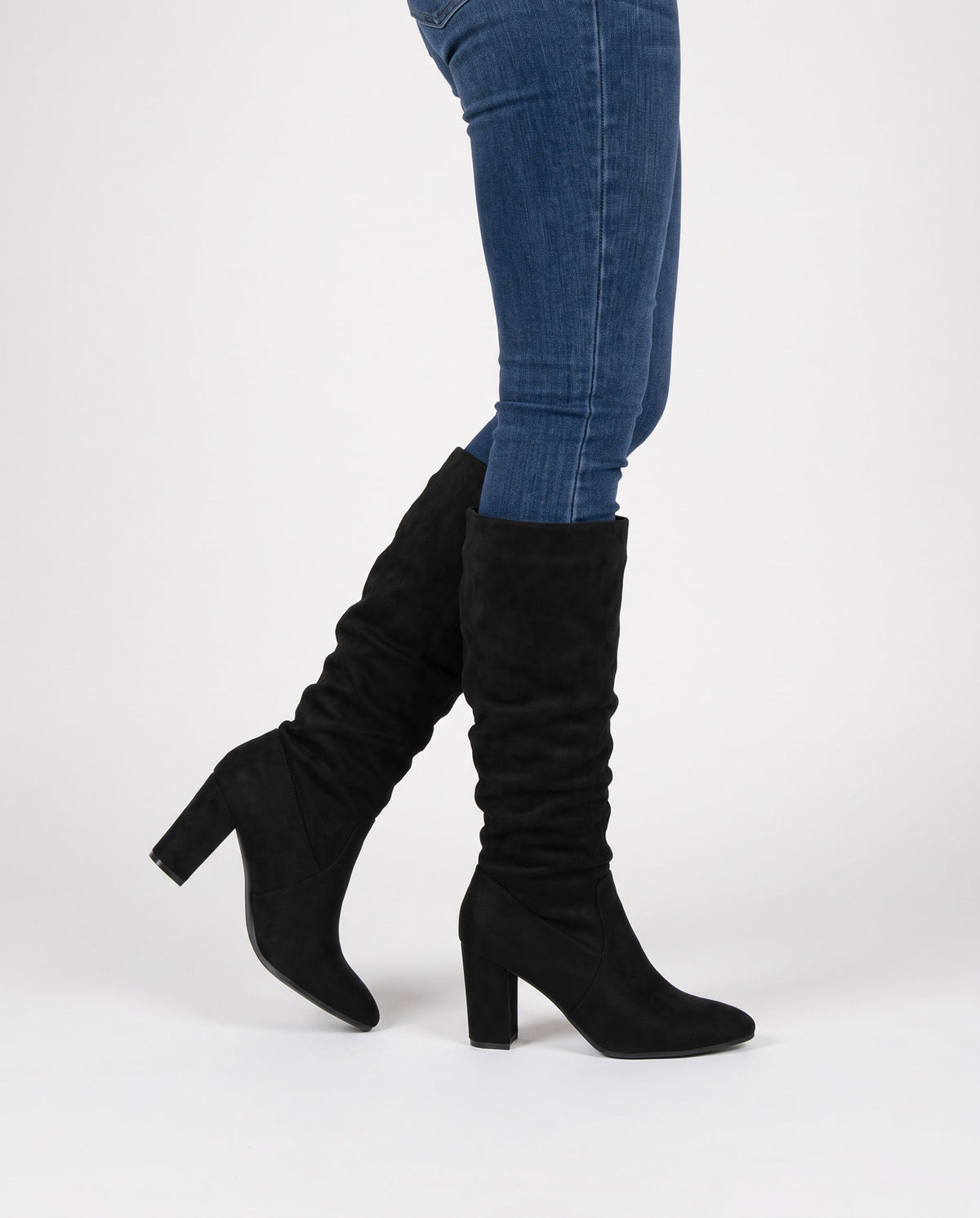Black block heel knee high boots in faux suede worn with skinny jeans - view 2