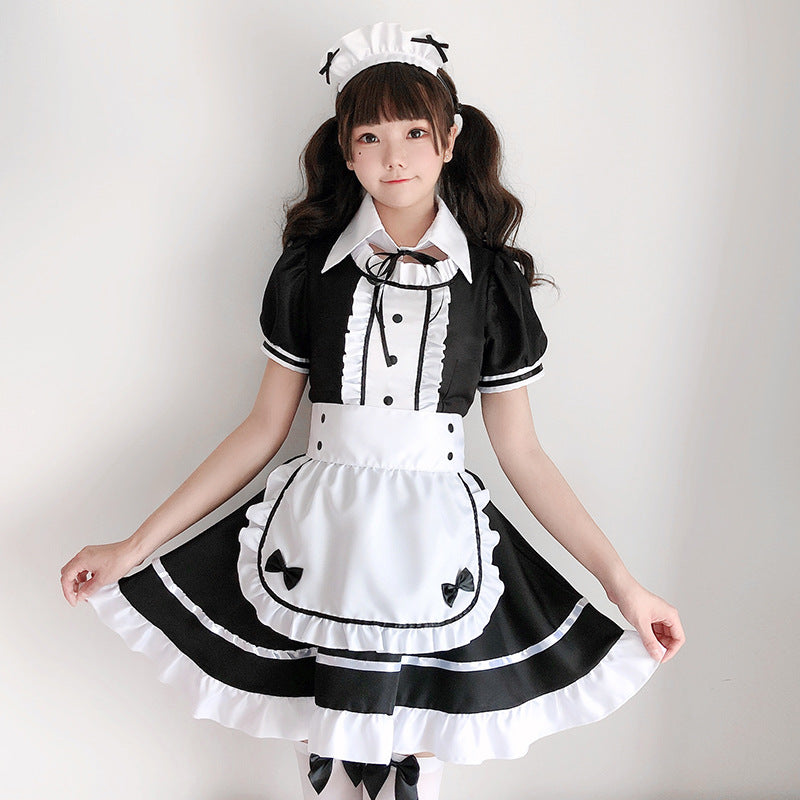Women's black and white maid Halloween costume with ruffled apron, puff sleeves and headpiece