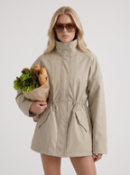 Khaki zip up utility jacket with funnel collar and cinched drawstring waist