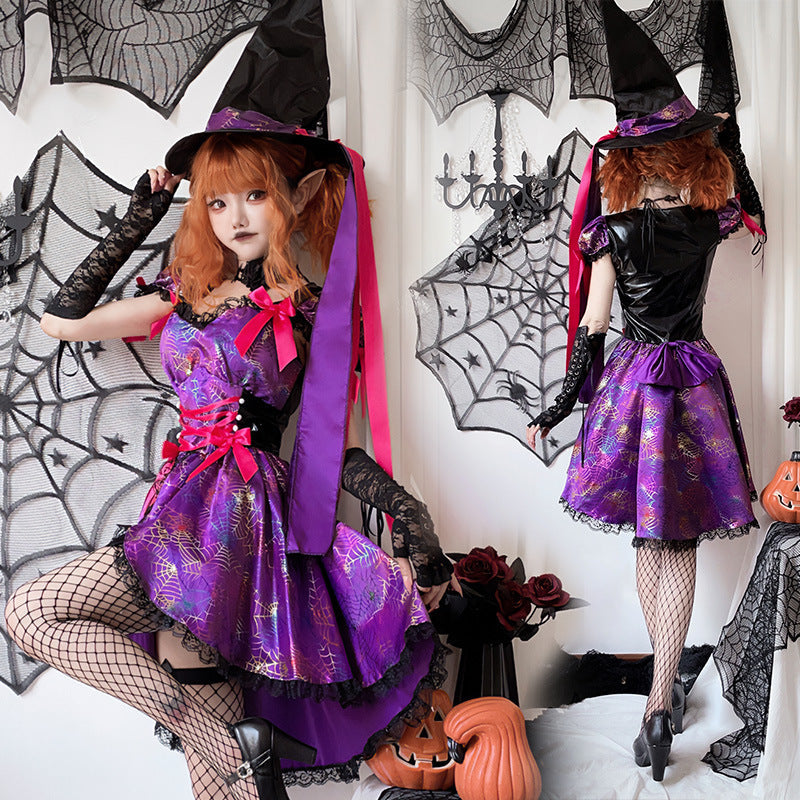 Woman wearing a purple spiderweb print witch costume dress with pink bows, lace-up waist and black lace trim - view 2