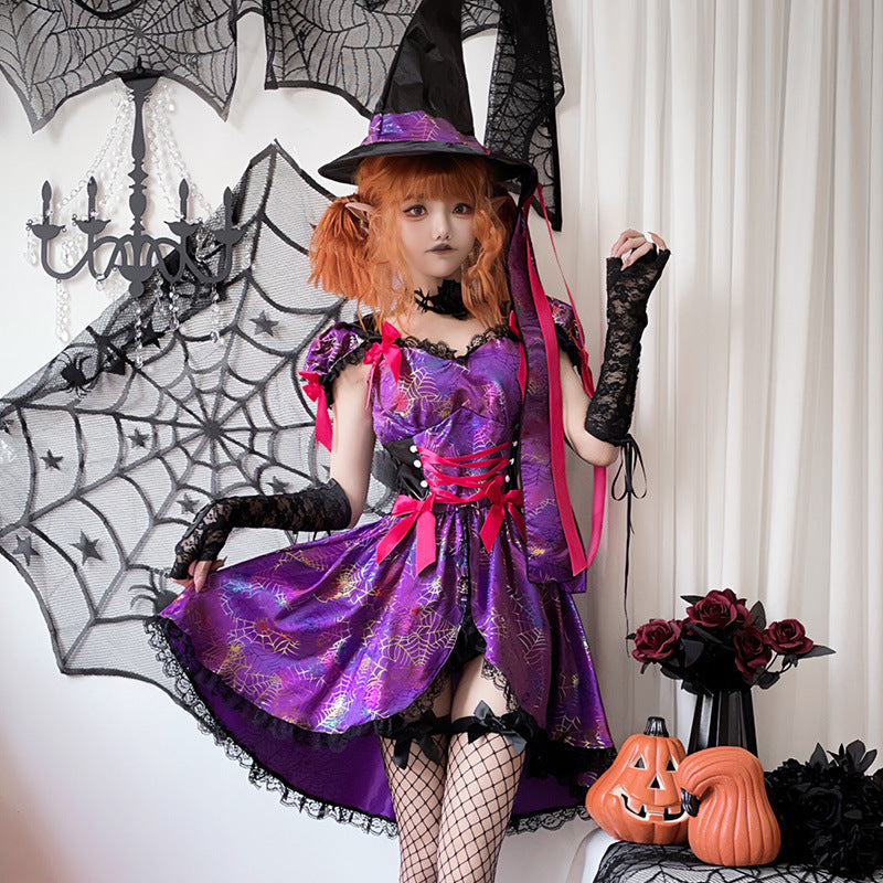Woman wearing a purple spiderweb print witch costume dress with pink bows, lace-up waist and black lace trim - view 4