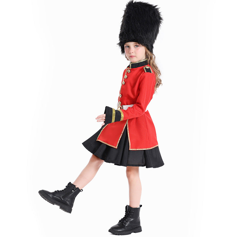 Girl wearing a red royal guard Halloween costume with gold trim, white belt, black skirt and tall black faux fur hat - view 2