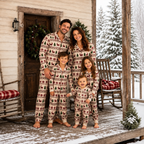 Cream reindeer Christmas pajama set worn by adults and kids on a snowy porch