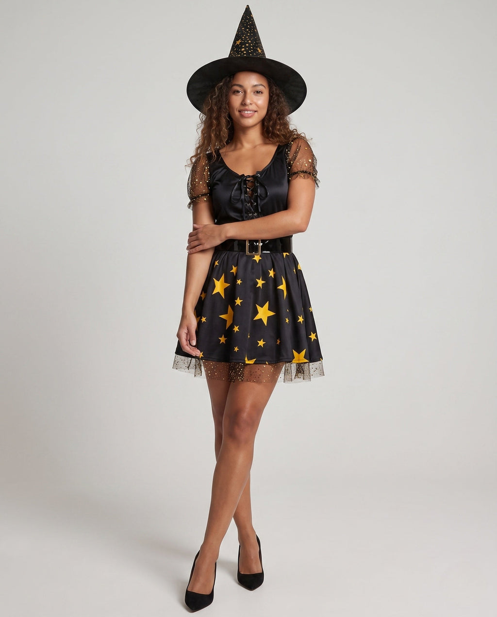 Women's black witch Halloween costume with gold star print skirt, lace-up bodice, mesh puff sleeves, buckle belt and pointed hat