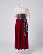 Women's pirate costume with blush lace-up cold-shoulder blouse, black corset belt, skull print sash and wine velvet maxi skirt - view 4