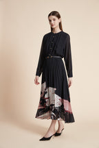 Black long sleeve midi dress with sheer sleeves, gold buttons and pleated skirt with pink and ivory floral hem print